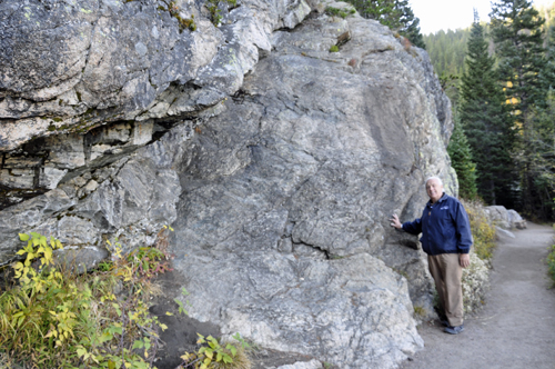 Lee Duquette by a big boulder alongside the paved trail